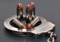 Five 44spl red tipped bullets inside of a metal handcuff Royalty Free Stock Photo