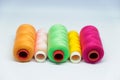 Five spools of colorful sewing thread. Royalty Free Stock Photo
