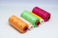 Five spools of colorful sewing thread. Royalty Free Stock Photo