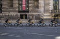 Five sportsmens are going after each other on bikes on the stre