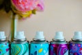 Five deodorant nozzles close up. Five colorful spray bottles with biege blurred background Royalty Free Stock Photo