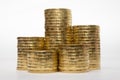 Five stacks of coins of different height on white background