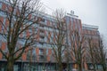 Five-star hotel `Crystal House` the facade of the building from courtyard, main entrance against gray sky behind trees