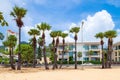 five-star hotel on the shores of Karon Beach with palm trees and yellow creaky sand