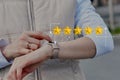 Five star rating concept. The person uses a smart watch Royalty Free Stock Photo