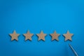 Five Star rating concept with wooden stars Royalty Free Stock Photo