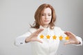 Five star rating or ranking, benchmarking concept. Woman assesses service, hotel, restaurant Royalty Free Stock Photo