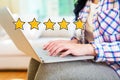 Five Star Rating with woman using a laptop