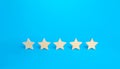 Five stars on a blue background. Rating evaluation concept. High satisfaction. Good reputation. Popularity rating of restaurants