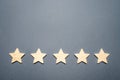 Five stars on a gray background. Rating and status of the restaurant or hotel. Prestige and a good title. High quality Royalty Free Stock Photo