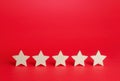 Five stars on a red background. Rating evaluation concept. Service quality feedback. High satisfaction. Good reputation