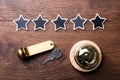 Five Stars, Service Bell And Hotel Key On Wooden Desk Royalty Free Stock Photo