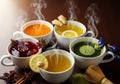 Five steaming cups of tea are arranged on a wooden table. Each cup contains a different type of tea Royalty Free Stock Photo