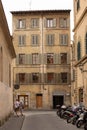 Five storey apartment building with shutters on the windows