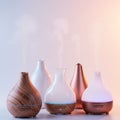 Five stylish aroma diffusers are arranged in a row. Each diffuser has a unique design: Royalty Free Stock Photo