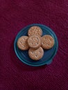 Five sweet cookies on top of a green lid