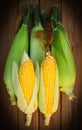 Five sweet corn on wood table