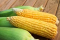 Five sweet corn on wood table