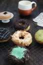 five sweet donuts with various toppings