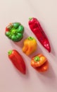 Five sweet peppers of different colors and sizes from your own garden lie on a pink background Royalty Free Stock Photo