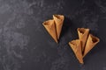 Five sweet wafer cones on a black background