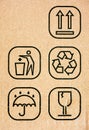 Five symbol on cardboard - This Way Up, Do Not Litter, Recycling, Keep Dry and Fragile Royalty Free Stock Photo