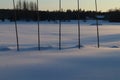 Five tall wooden poles in winter landscape