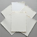 Sheet, cream-colored with deckled edges, displays a soft, fibrous textu Royalty Free Stock Photo