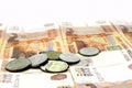 Five thousandth bills on a table along with coins of different denominations. Russian rubles Royalty Free Stock Photo