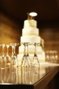 Five tiered wedding cake with empty champagne flutes on table Royalty Free Stock Photo