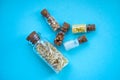 Five tiny glass jar with rice, buckwheat, millet, sugar and barley on blue background, top view. Concept of nutrition, vegetarian Royalty Free Stock Photo