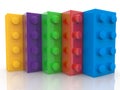 Five toy bricks one after the other in different colors on white Royalty Free Stock Photo