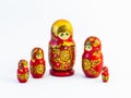 Five traditional Russian matryoshka dolls on white background