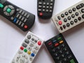 Five tv remotes on a white background Royalty Free Stock Photo