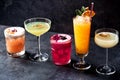 Five variously colored cocktails teasing the drinker