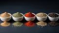 Five Vibrant Spices in White Bowls with Spilled Piles on Dark Background, Dramatic Studio Lighting Royalty Free Stock Photo