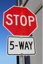 Five Way Stop Sign Beside Building Royalty Free Stock Photo