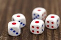 Five white dice shows the number 1 on a wooden table. Five white dice showing one Royalty Free Stock Photo