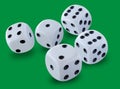 Five white dices size thrown in a craps game, yatzy or any kind of dice game against a green background