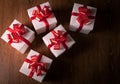 White festive gift boxes with red bows on a wooden table Royalty Free Stock Photo