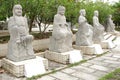 Five white marble Buddha statues in a garden, China