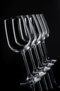 Five wine glasses in row tilted in perspective on black background Royalty Free Stock Photo