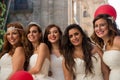 Five women dressed as brides