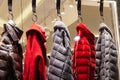 Five women`s jackets on store hangers. outerwear winter fashion clothes