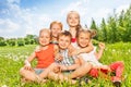 Five wonderful kids sitting together on a meadow Royalty Free Stock Photo