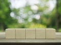 Five wood block cubes on wooden table