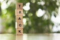 Five wooden cubes, blocks standing on table and showing word TRACK. Conceptual image about human rights, education