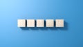 Five wooden cubes isolated on blue background.