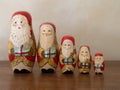 Five Wooden Santa Nesting Dolls Holding Gifts