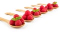 Five Wooden Spoons Filled with Fresh Raspberries and Mint Leaves on a White Background raspberry fruit Royalty Free Stock Photo
